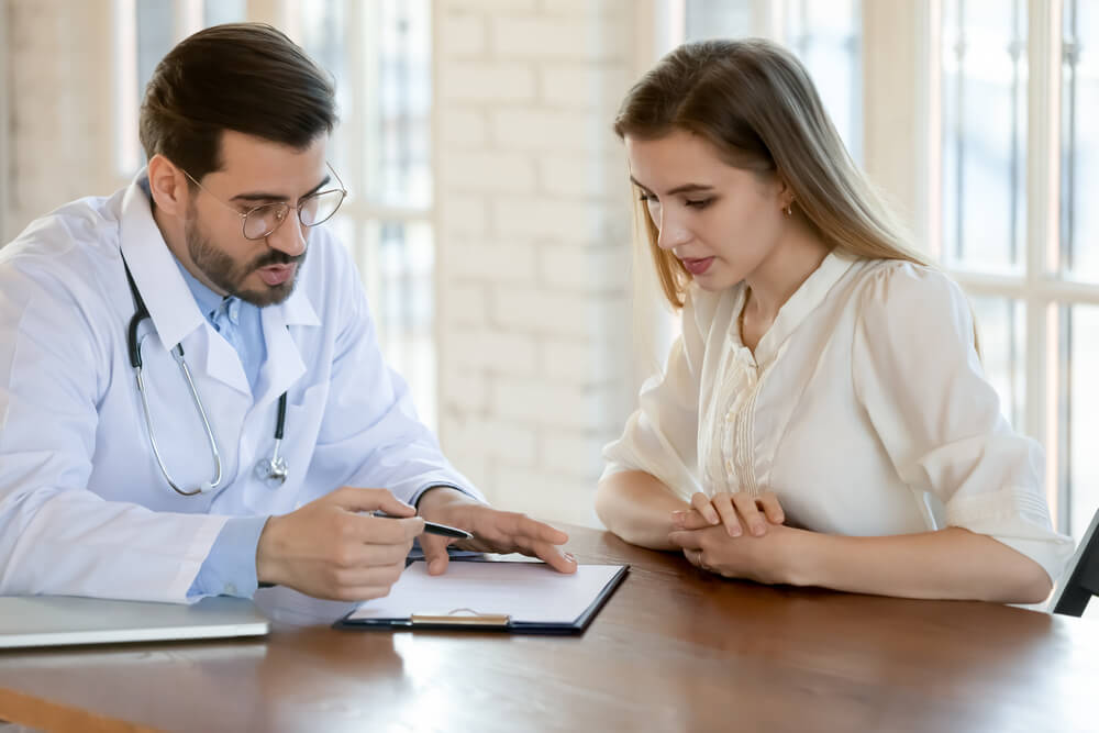  Gynecologist Consulting Young Female Patient at Hospital Cabinet