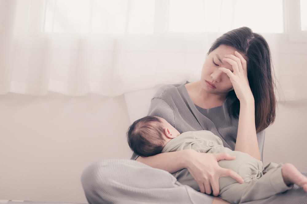 Tired Mother Suffering From Experiencing Postnatal Depression