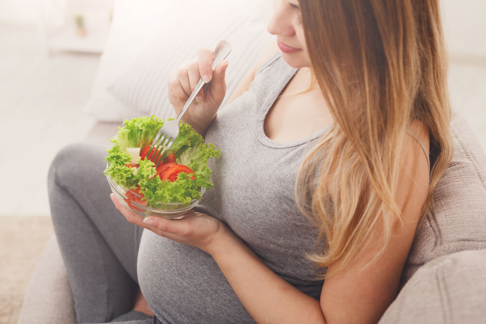 Young Pregnant Woman Eating Green Salad