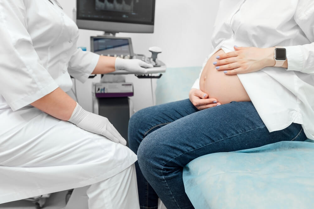 Pregnant Woman Undergoing Ultrasound Test at Gynecologist Office