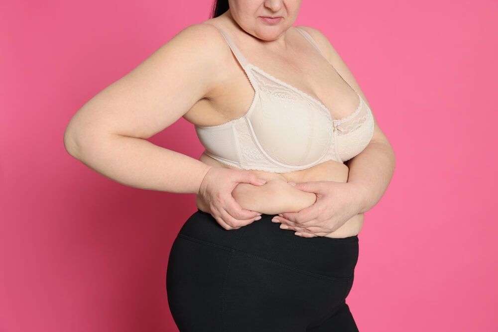 Obese Woman on Pink Background; Weight Loss Surgery