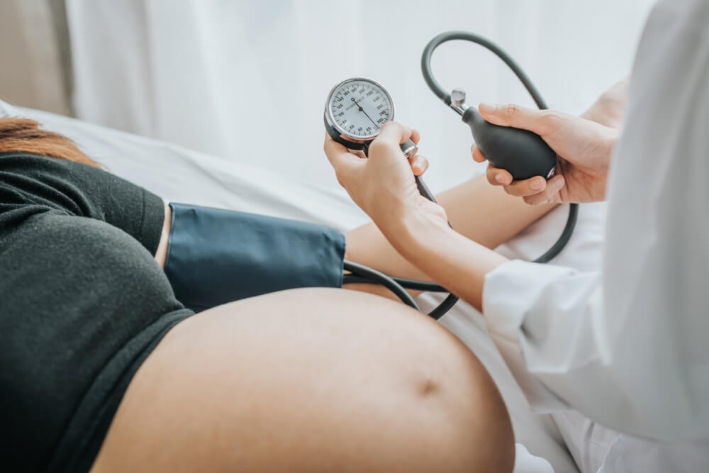 Doctor Checking Blood Pressure of a Pregnant Woman