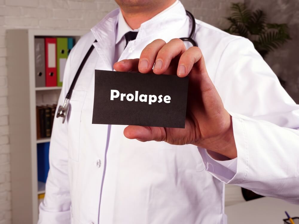 Doctor Holding a Brick with Prolapse Written on it.