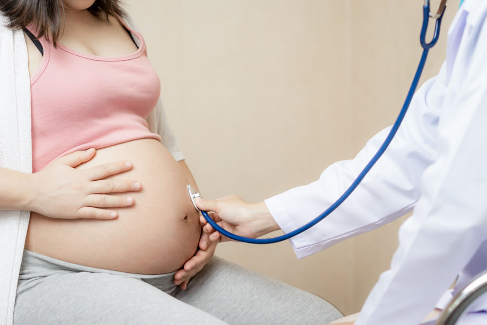 Happy Pregnant Woman Visit Gynecologist Doctor at Hospital