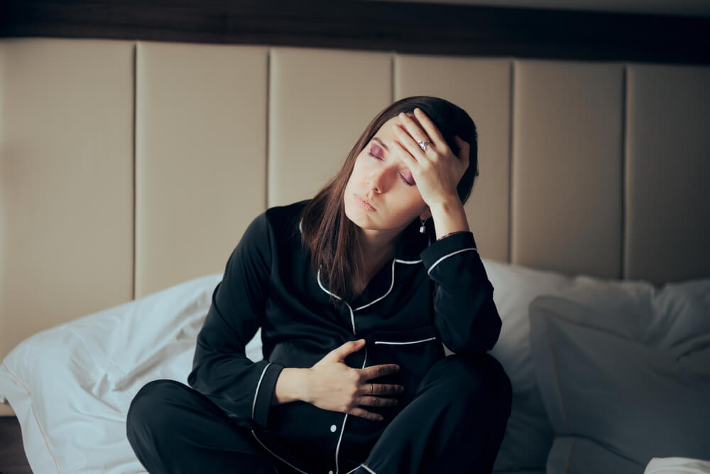 Pregnant Woman Feeling Sick Resting in Bed.