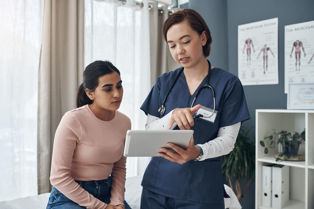 Shot of a Young Female Doctor Talking to a Patient in an Office.