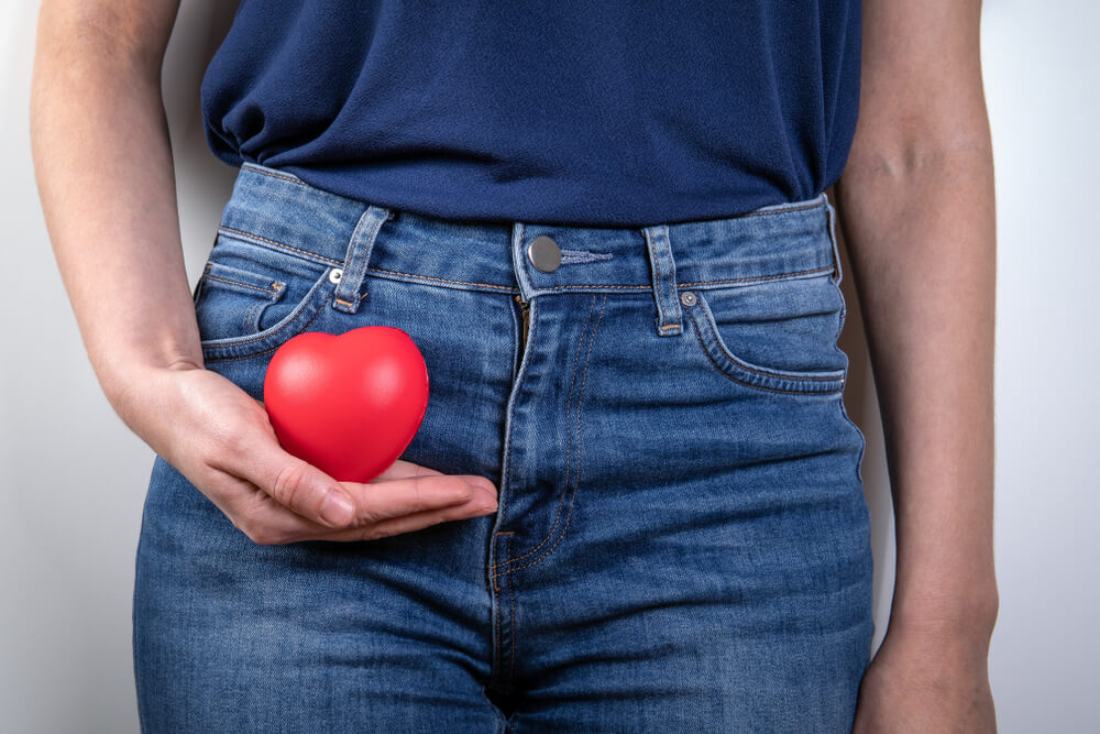 Reproductive Health, Menopause, Hygiene and Vaginal Candidiasis Concept. Red Rubber Heart in Woman’s Hand