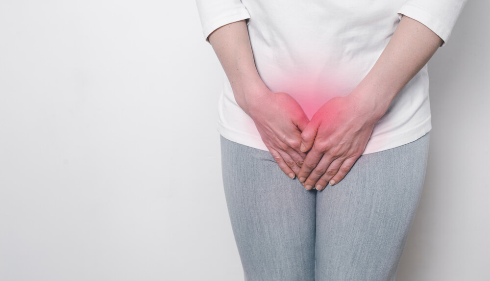 A Woman Holds Her Hands for a Sore Crotch. Gynecological Problems in the Lower Abdomen. Inflammation of the Bladder