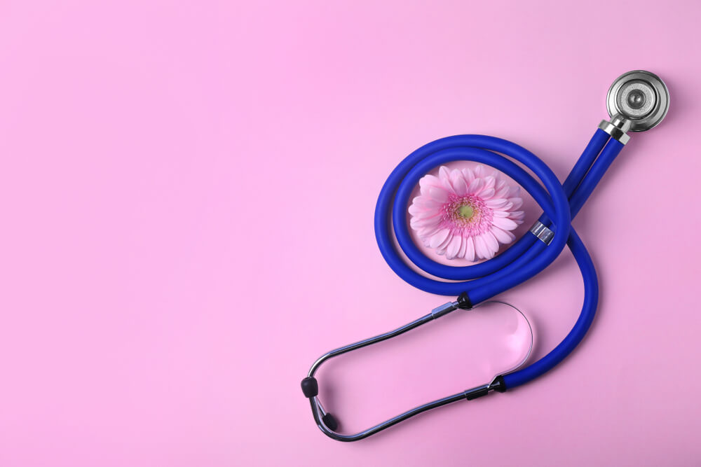 Flat Lay Composition With Stethoscope And Flower On Pink Background Space For Text Gynecology Concept