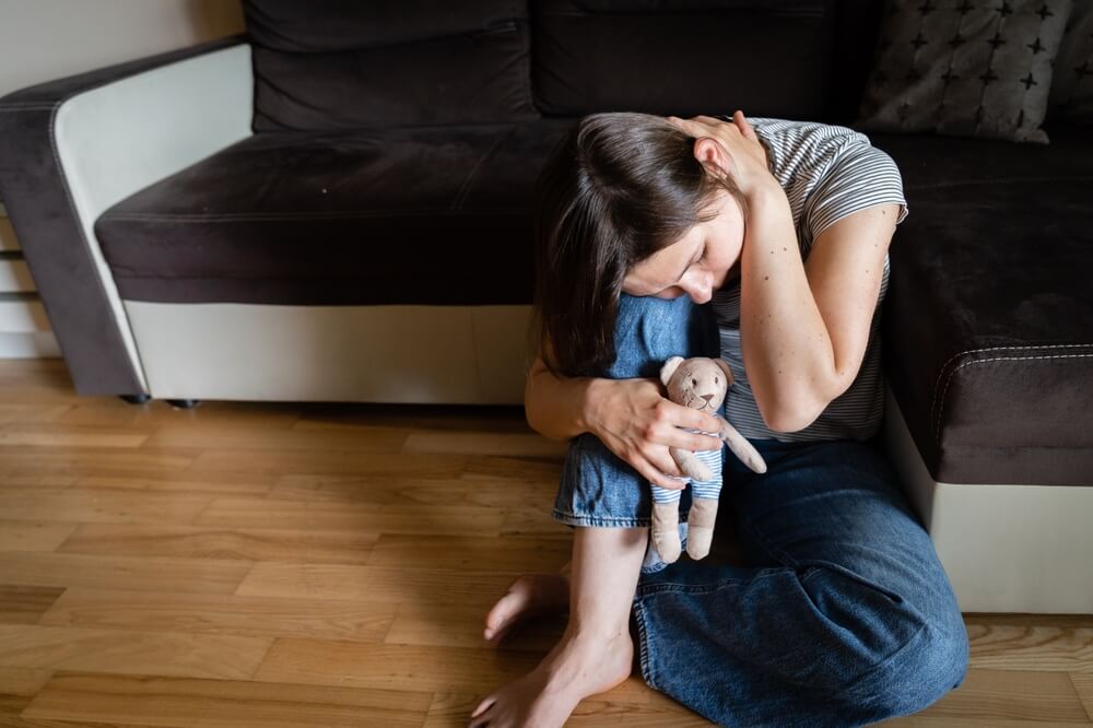 Perinatal Loss Reproductive Chalenge Concept - Female Holding A Teddy Bear Toy