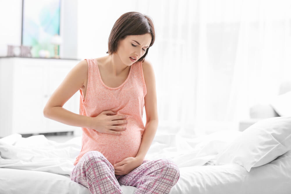 Young Pregnant Woman Suffering From Abdominal Pain at Home