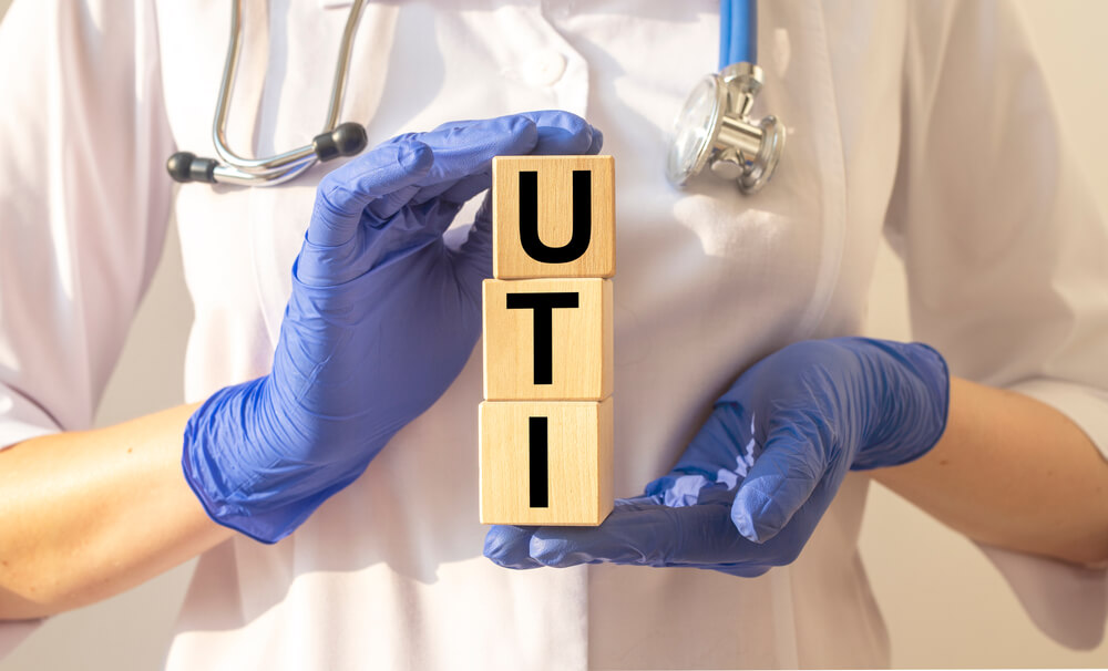 Word Uti Concept, Urinary Tract Infection Inscription on Cubes in Doctor Hands.