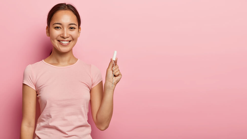 Pretty Young Woman Holds Cotton Tampon