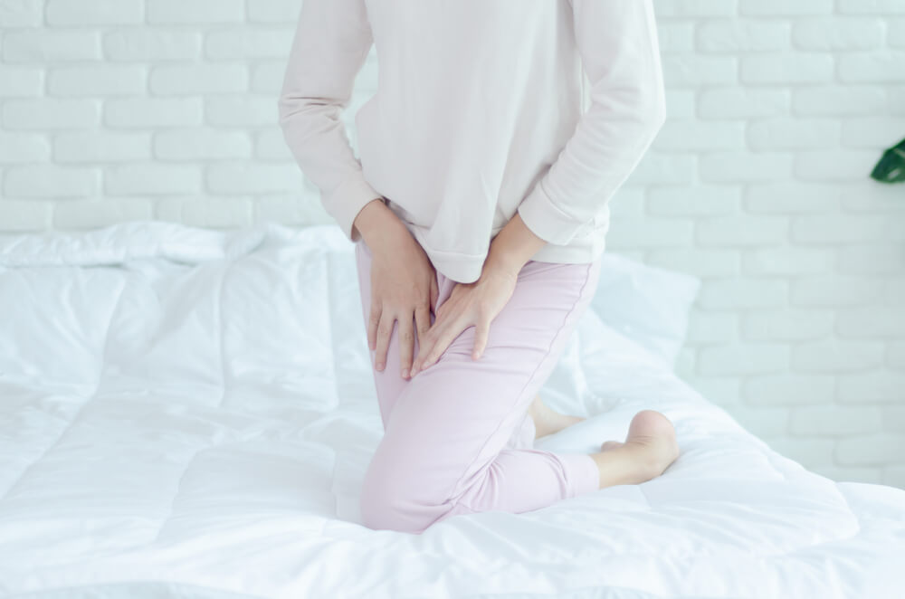 Woman Wearing Pink Pants the Itching on Vaginal. The Woman’s Hand Placed Between Her Legs