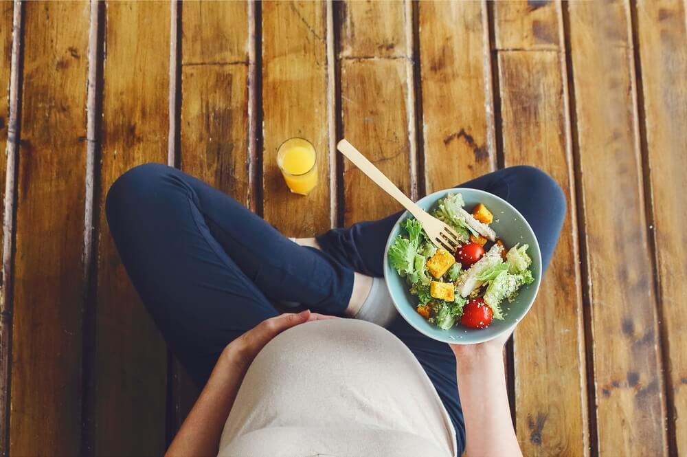 Pregnant Woman With Fresh Salad Bowl and Orange Juice