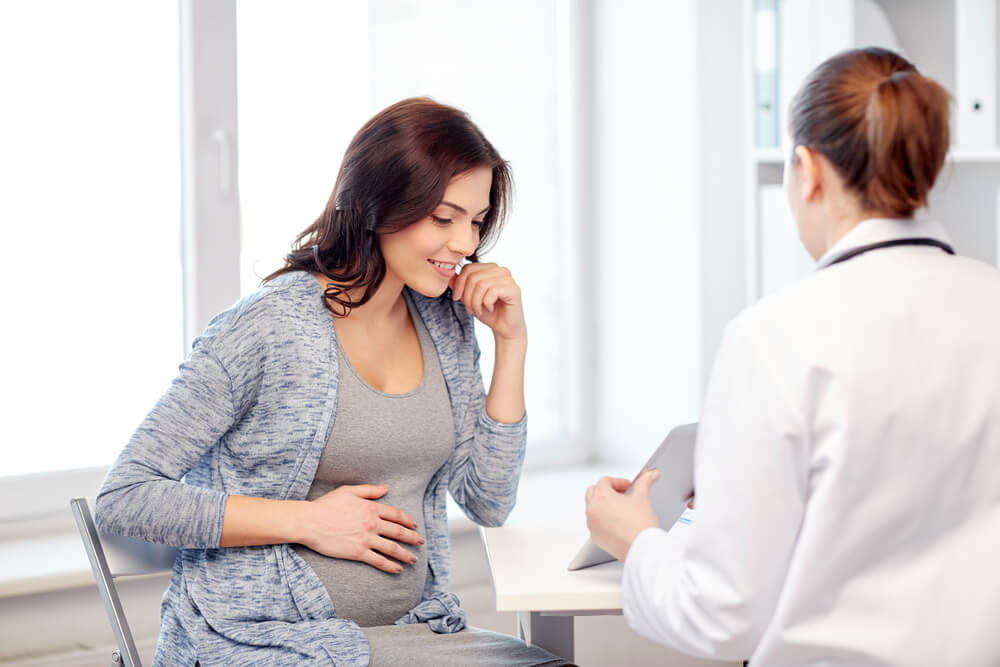 A woman at the early pregnancy stage at the gynecologist's appointment.