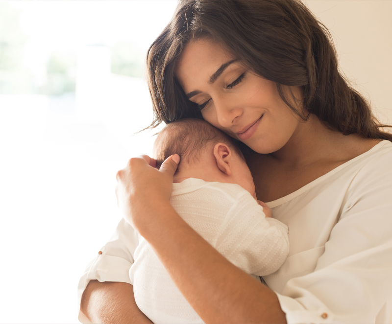 Obstetrics-service Woman holding a baby with a smile