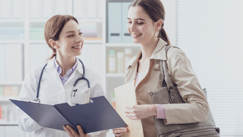 doctor showing medical records to a patient