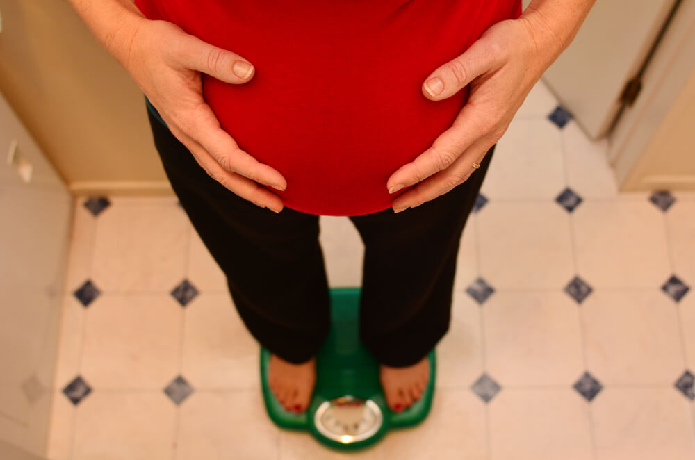 Pregnant Woman Standing On The Scales