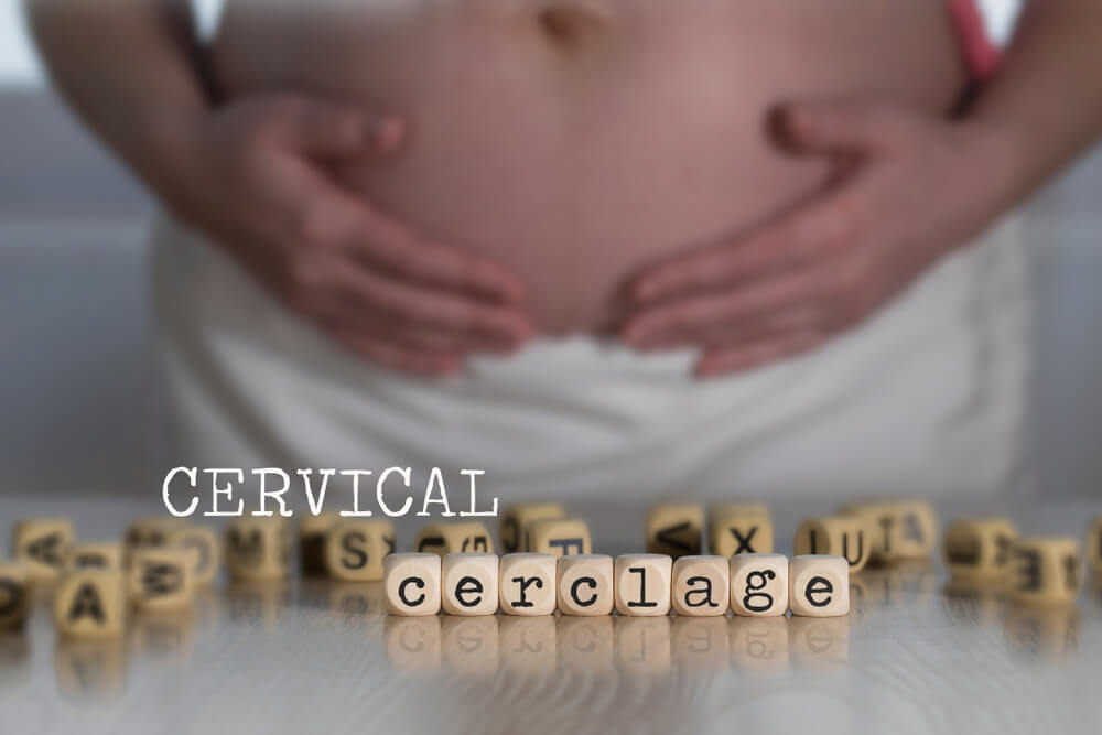 Words Cervical Cerclage Composed of Wooden Letters. Pregnant Woman in the Background