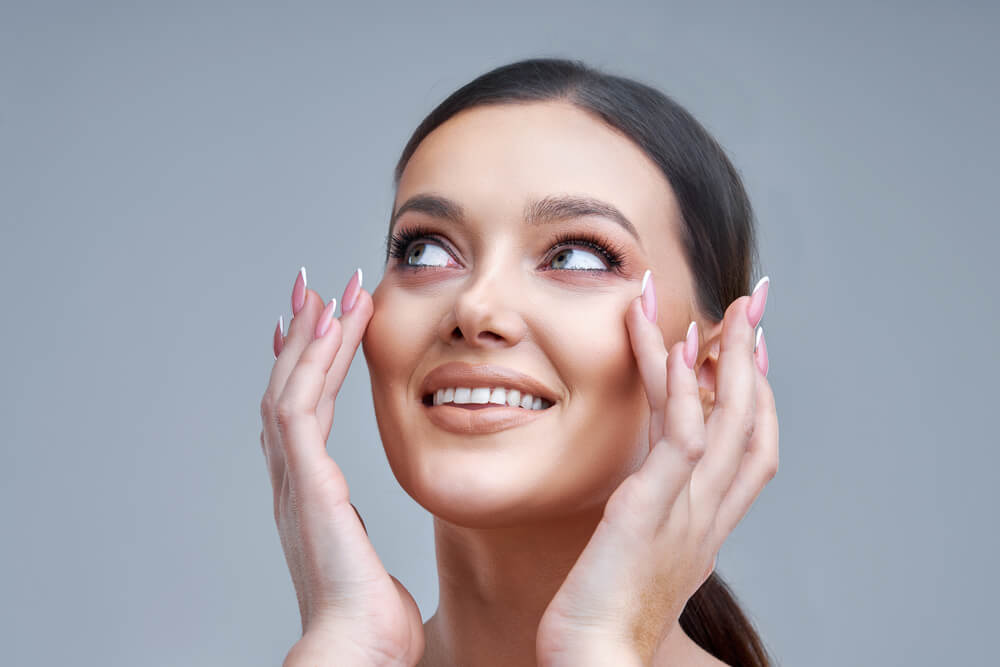 Portrait of Beautiful Woman on Gray Background