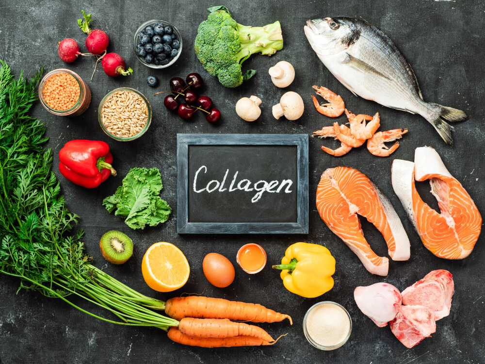Food Rich in Collagen. Various Food Ingredients and Chalkboard With Collagen Letters Over Dark Background.