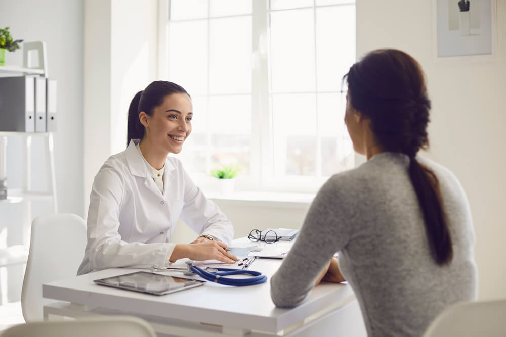 Doctor and Patient in Consultation at the Clinic Office.