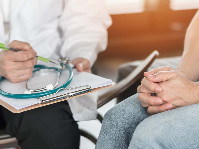 Gynecologist speaking to an older woman