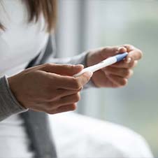 woman looking at pregnancy test