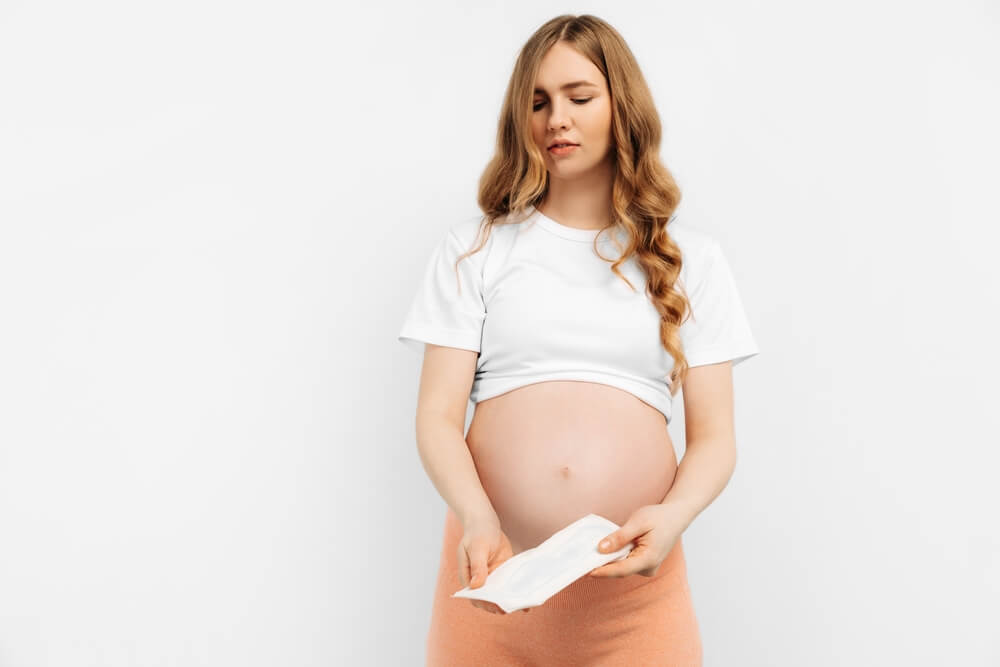 Pregnant Woman Holds A Sanitary Pa