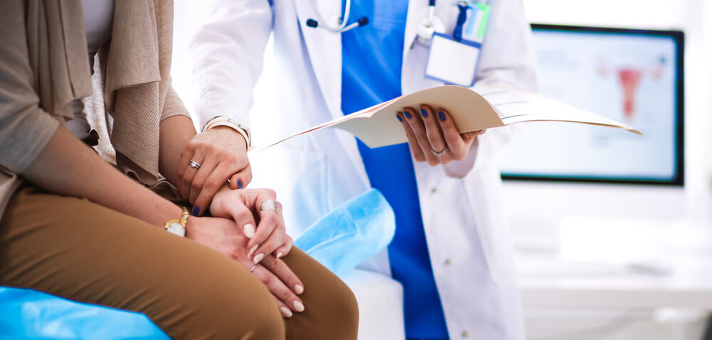 Doctor and Patient Discussing Something While Sitting at the Table.