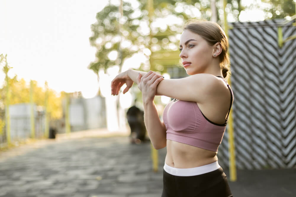 Young Fit Woman Doing Hand Stretching on the Sports Ground. Healthy Lifestyle.