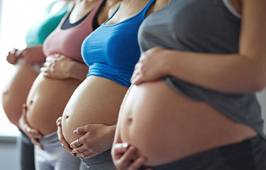 Pregnant women cradling their bellies, celebrating the journey of motherhood.
