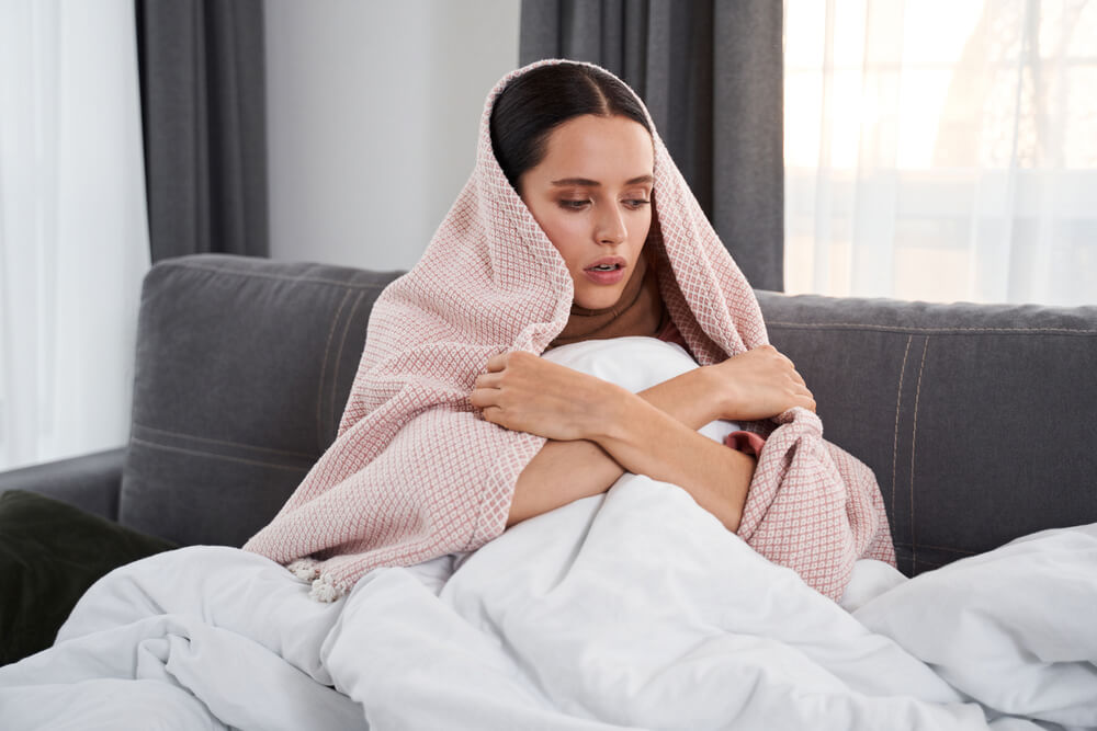 Young Pretty Brunette Having Chills and Warming Herself While Having Seasonal Virus Problem