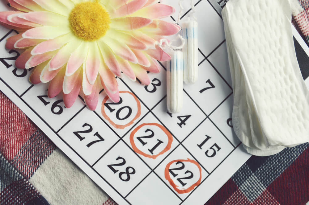 Menstruation Calendar With Cotton Tampons,Orange Gerber,Sanitary Pads on a Red Background