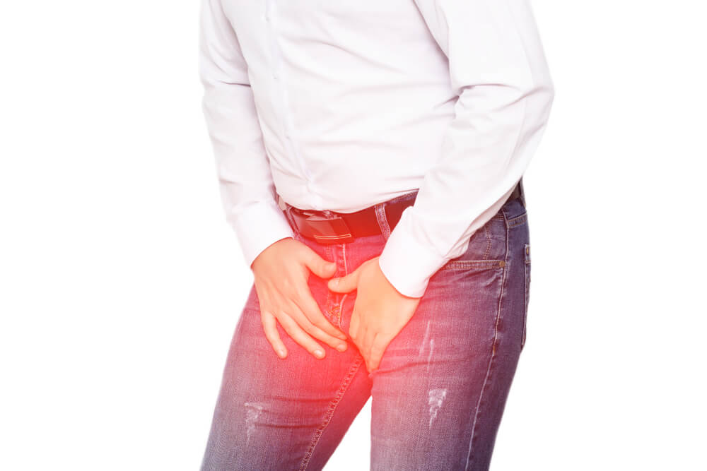 A Man in a White Shirt Holds on to His Groin, the Concept of Pain and Inflammation in the Groin