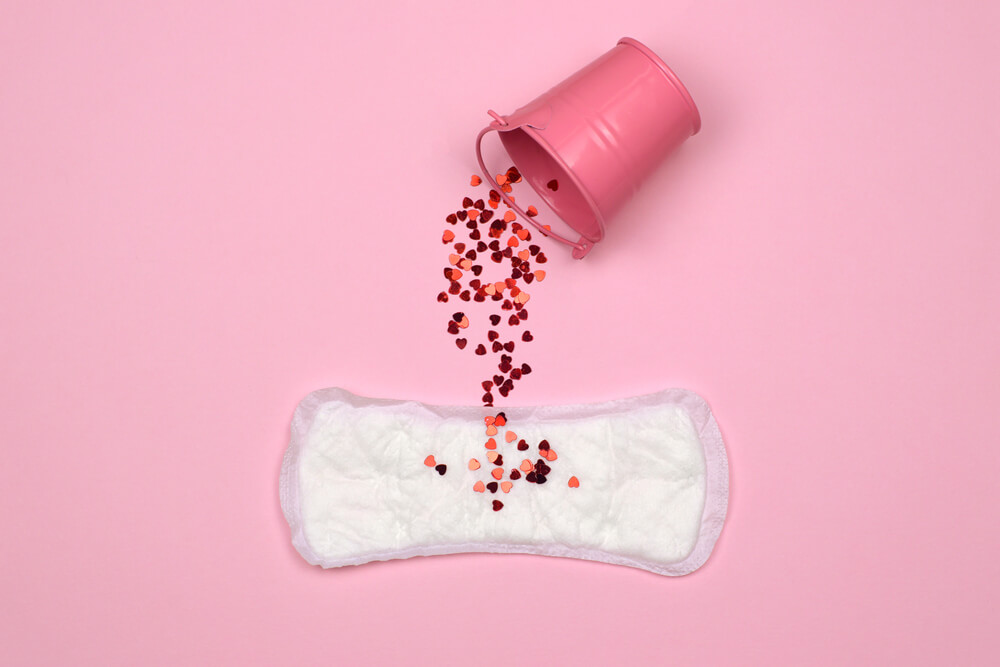 Feminine Hygiene Pad, Bucket and Red Glitter. Menstruation Concept on Pink Background