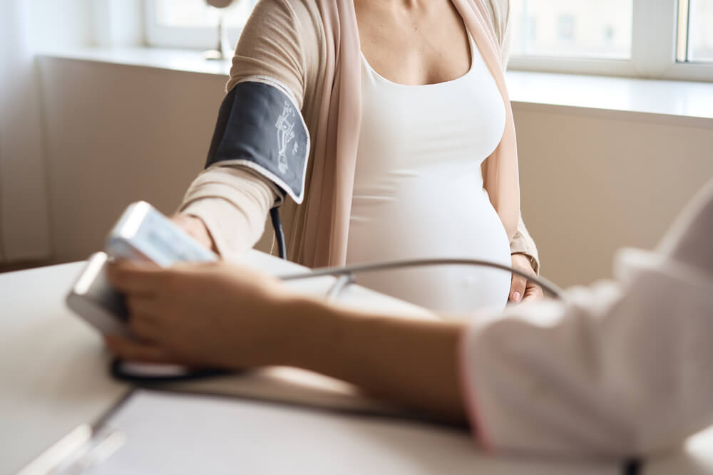 Doctor Measuring Blood Pressure of Her Pregnant Patient