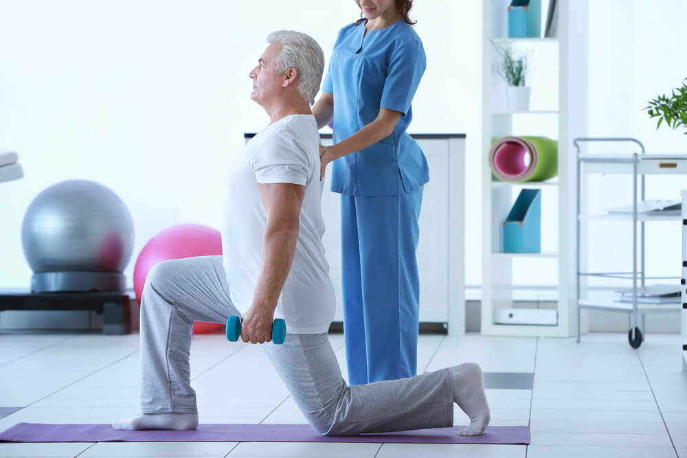 Physiotherapist Working With Patient in Clinic