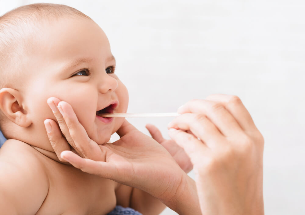 Pediatric Dentistry. Dentist Examining Little Baby’s Mouth. Oral Health and Hygiene