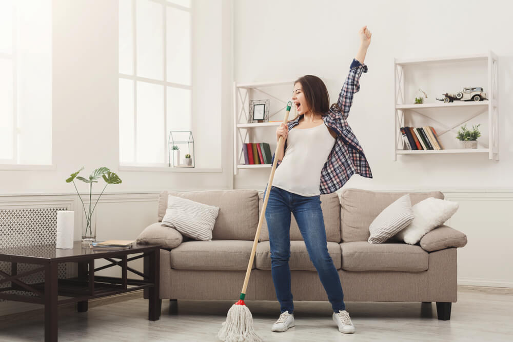 Happy Woman Cleaning Home, Singing at Mop Like at Microphone and Having Fun