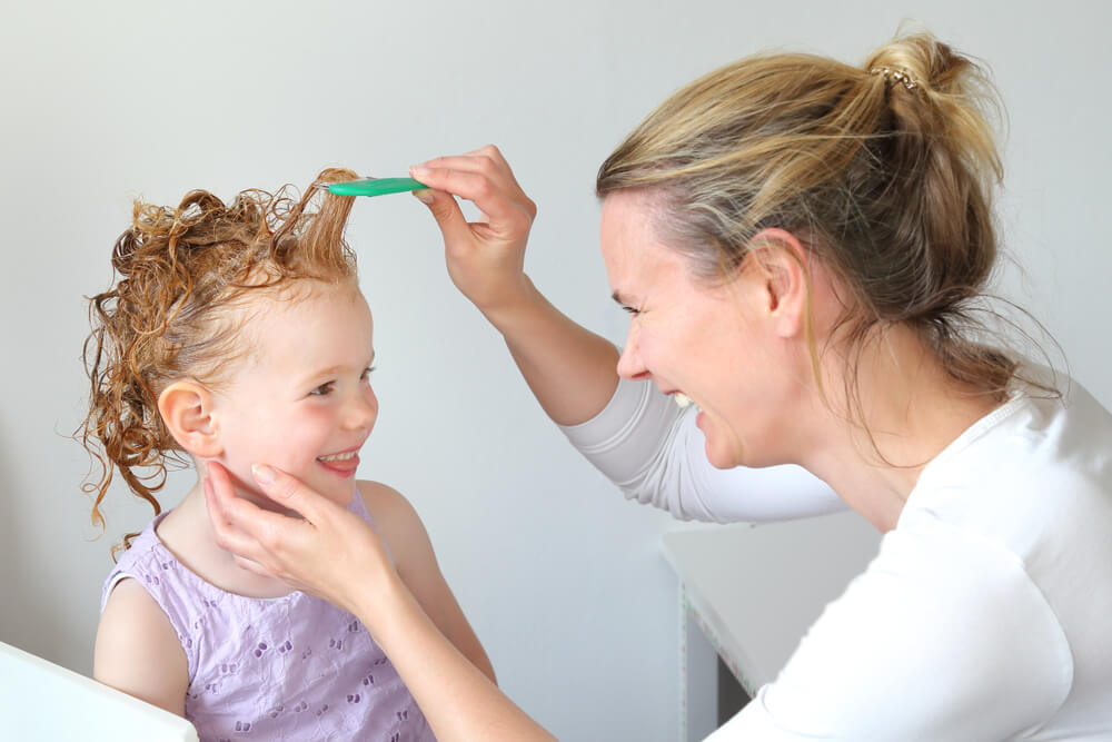 Washing Out Head Lice in the Hair of a Child