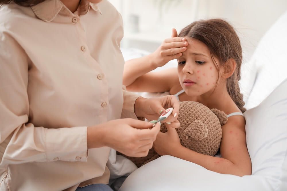 Woman Measuring Temperature of Her Little Girl Ill With Chickenpox at Home