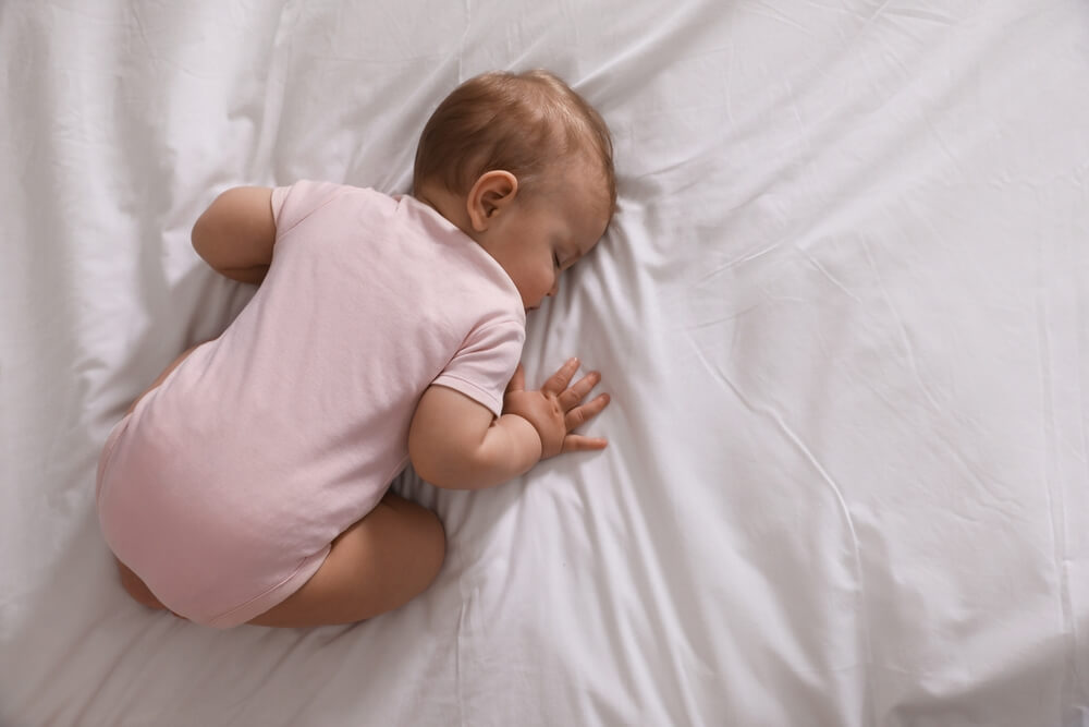 Adorable Little Baby Sleeping On Bed, Top View.