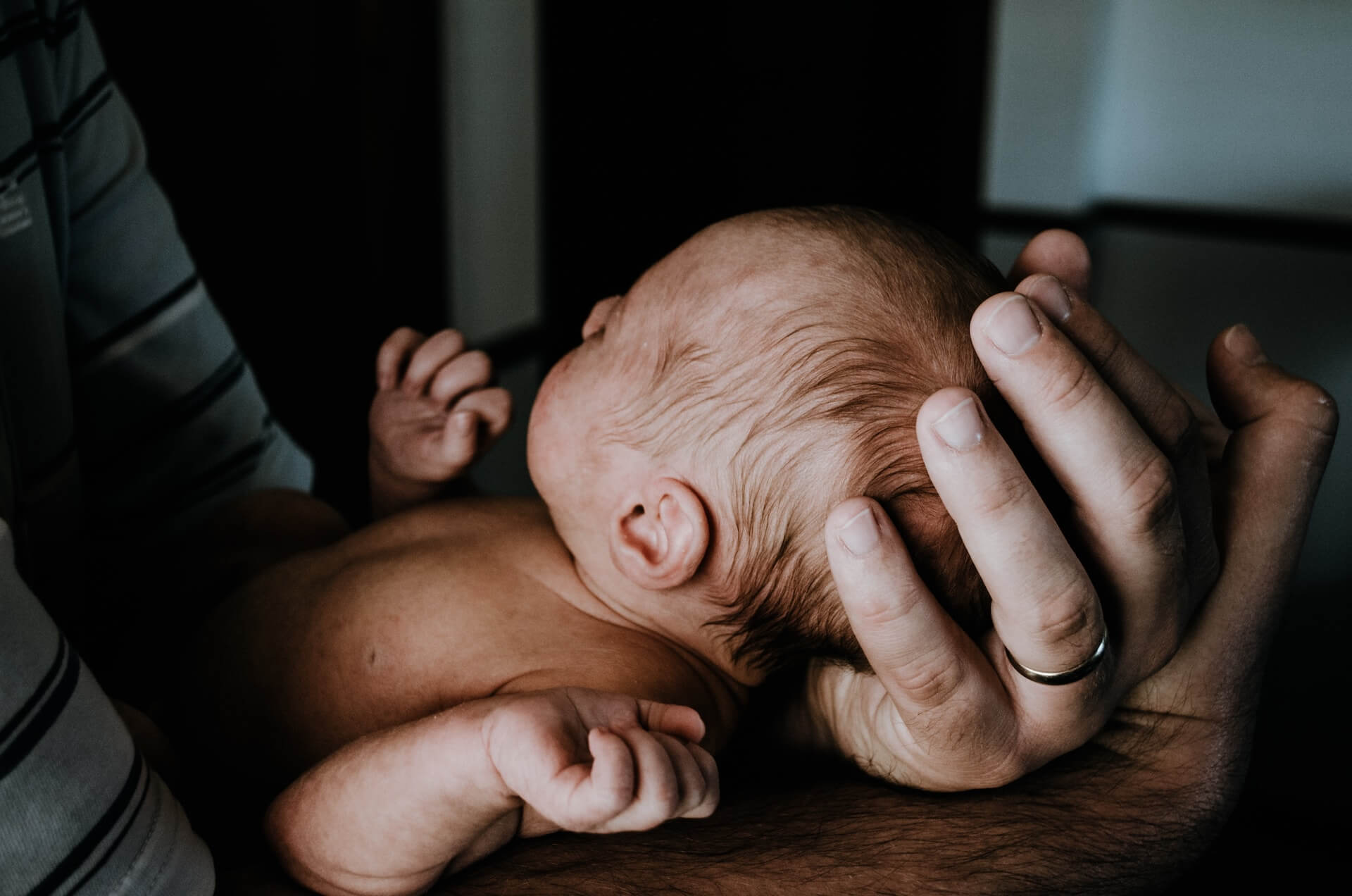 Father Holding Baby Carefully