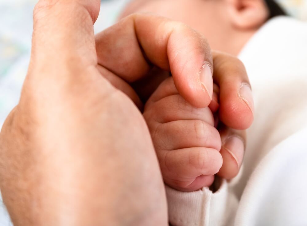 Newborn Baby Lying On A Crib Showing The Dangers In The Crib And The Need For Parental Care