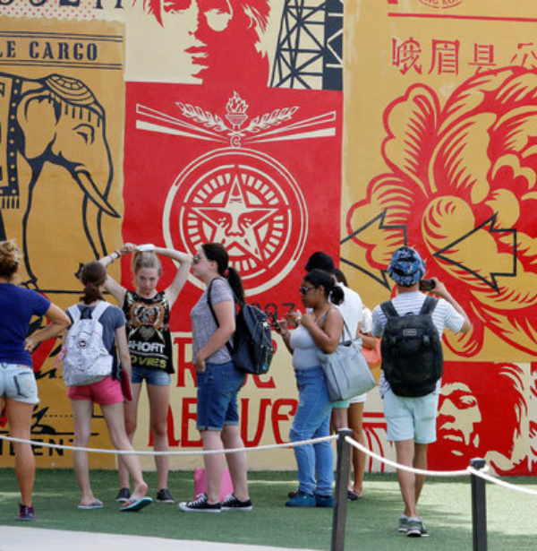 Visitors walk throuogh the Wynwood arts district of Miami