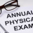 Annual Physical Exam Form With Stethoscope and Spectacles Over White Desk
