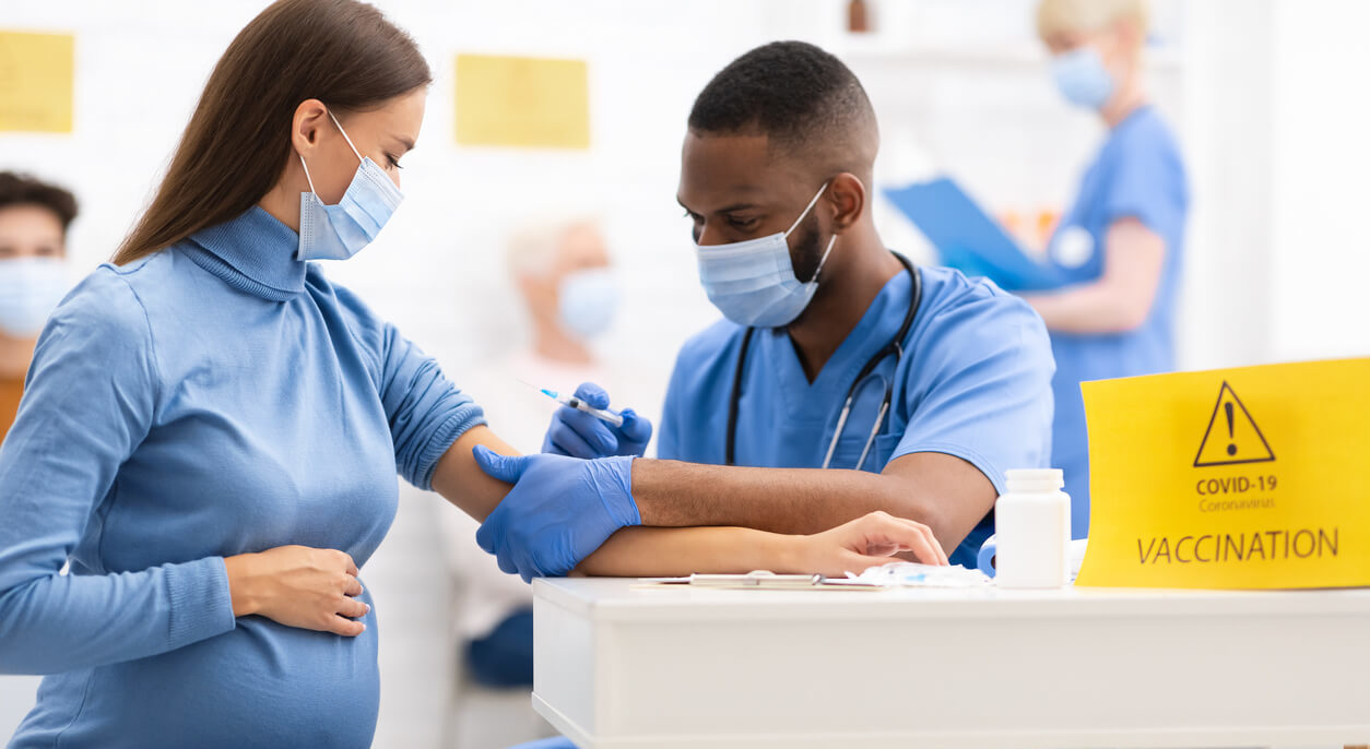 Pregnant Woman Receiving Coronavirus Vaccine Intramuscular Injection Shot in Arm