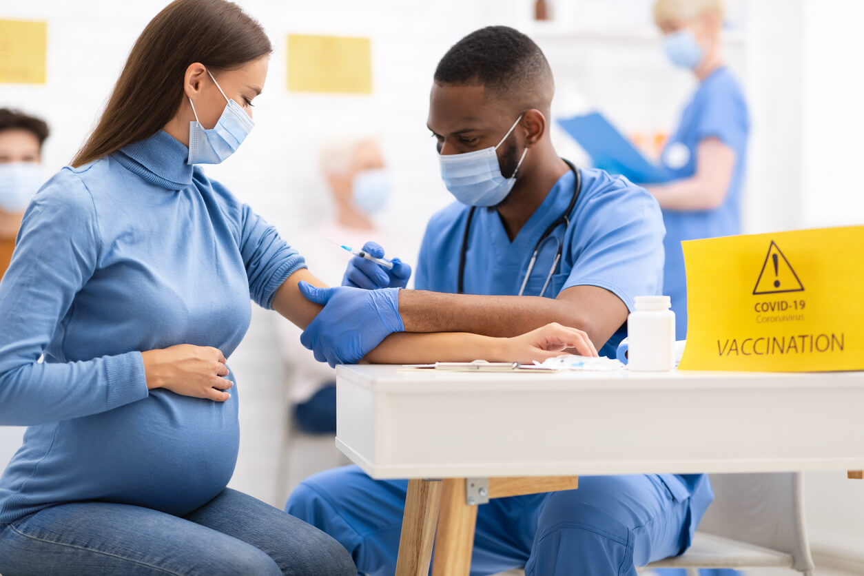 Pregnant Woman Receiving Coronavirus Vaccine Intramuscular Injection Shot in Arm